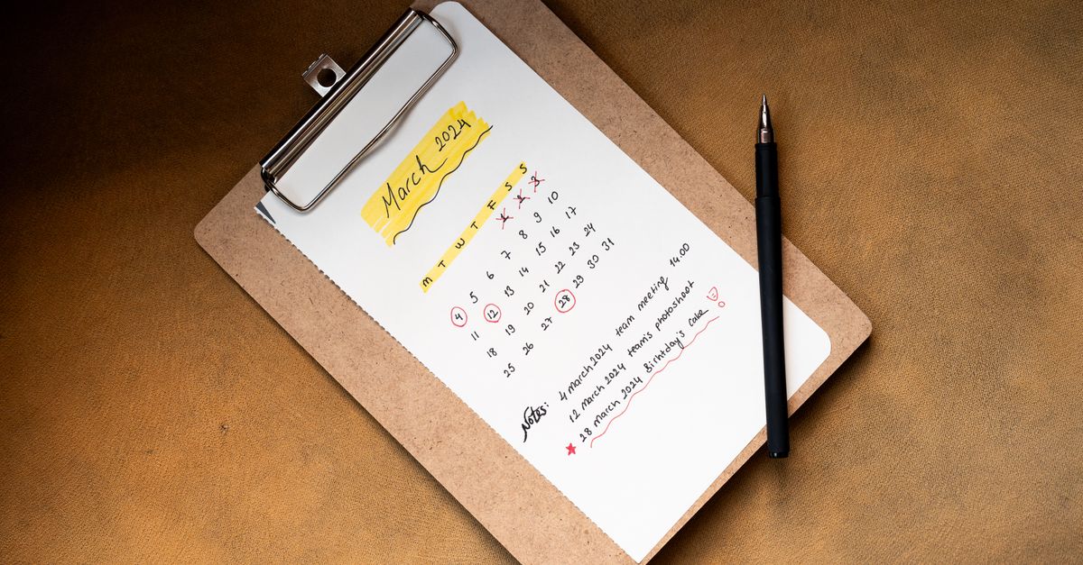 Top view of a March 2024 calendar on a clipboard with a pen, ideal for planning or scheduling content.